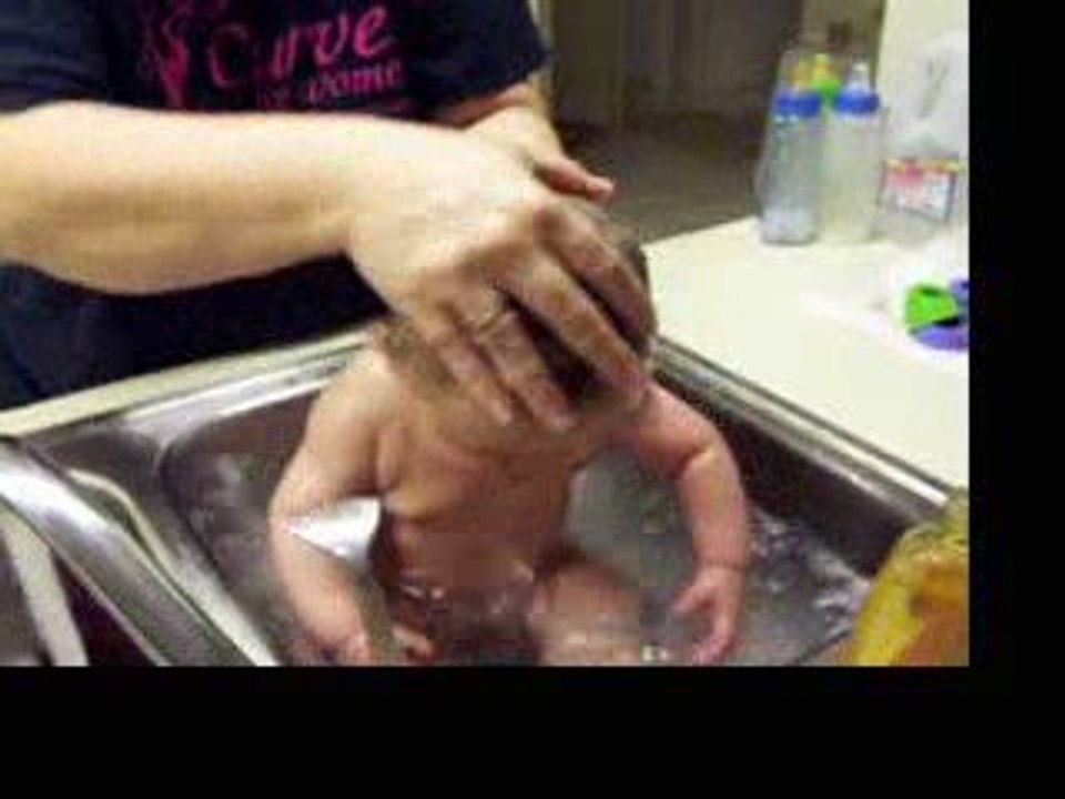 Izzy taking a bath and playing the drum