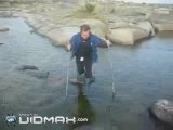 Régis travers un cours d'eau avec des batons