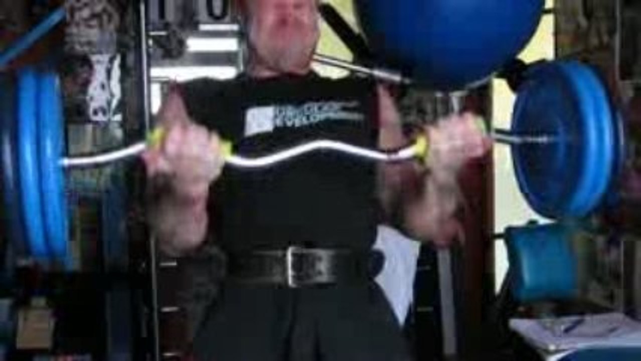 Michael Gundill performs barbell biceps curls