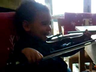 Little Max playing violin.....or clapping with his bow ....