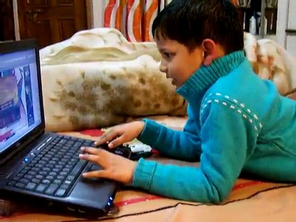 Shreyash playing game on laptop