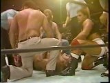 John Studd attacks Andre with shears