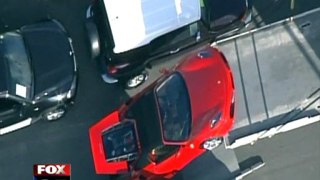 Crash - Ferrari takes fall off delivery tuck