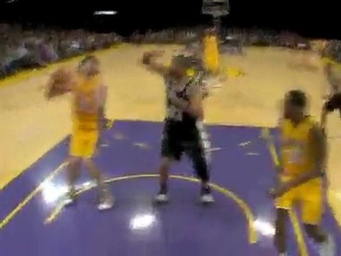 Ron Artest goes around Tim Duncan with a bounce pass to Pau