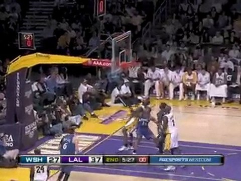 Kobe Bryant buries a tough jumper with a hand in his face.