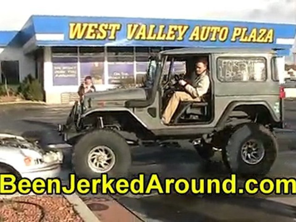 Land Cruiser (FJ40) crawls on a car @ West Valley Auto Plaza