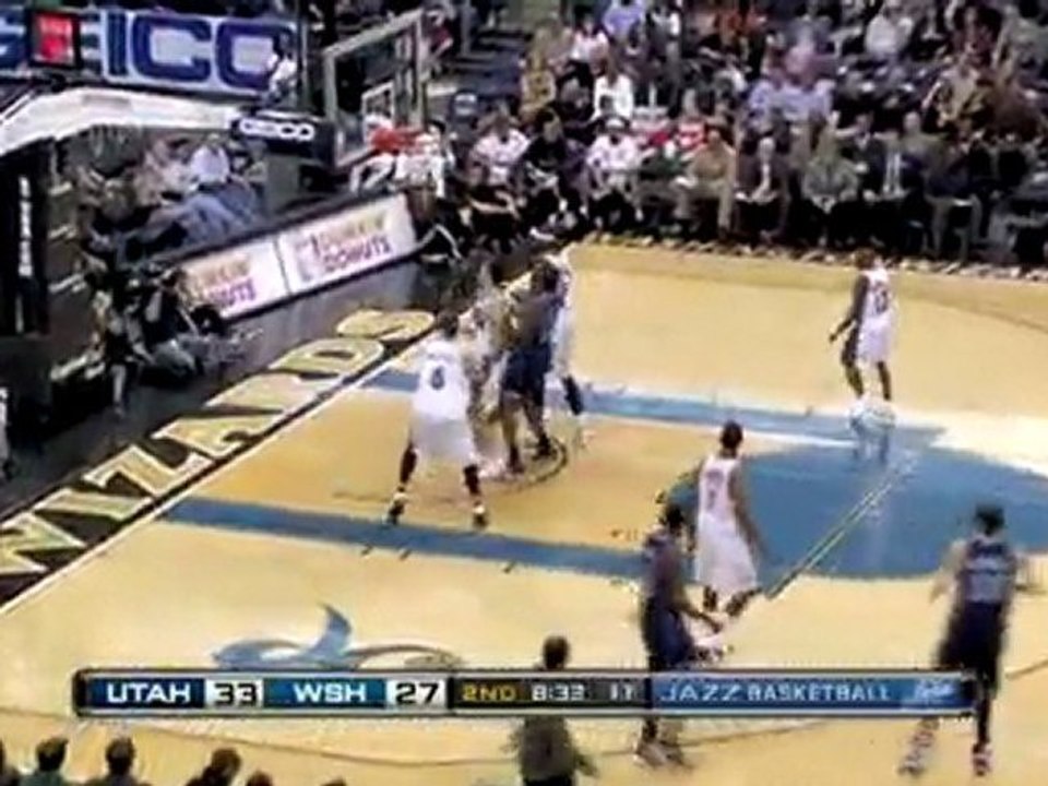 Mehmet Okur drives to the basket and drains the tough shot.