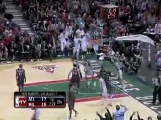 Carlos Delfino drives down the lane and dunks over two Hawks