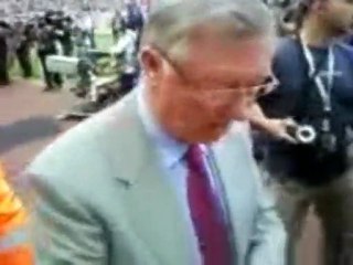 Sir Alex Ferguson signs green and gold scarf