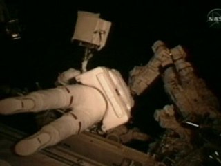 Crew untangles cable on space shuttle boom