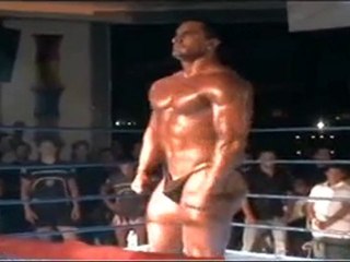 Bodybuilder posing on a ring