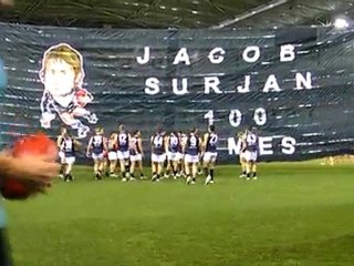 Pt Adel players running through a banner