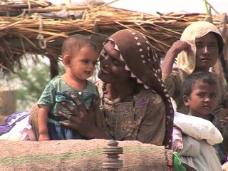 Families stranded on embankments by rising flood waters