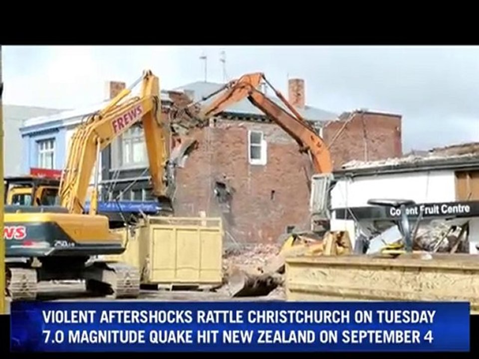 Workers in Christchurch tear down buildings damaged by the quake