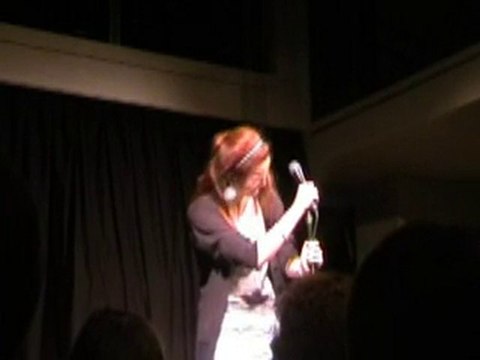 Mother distracts daughter during open mic stand up comedy.
