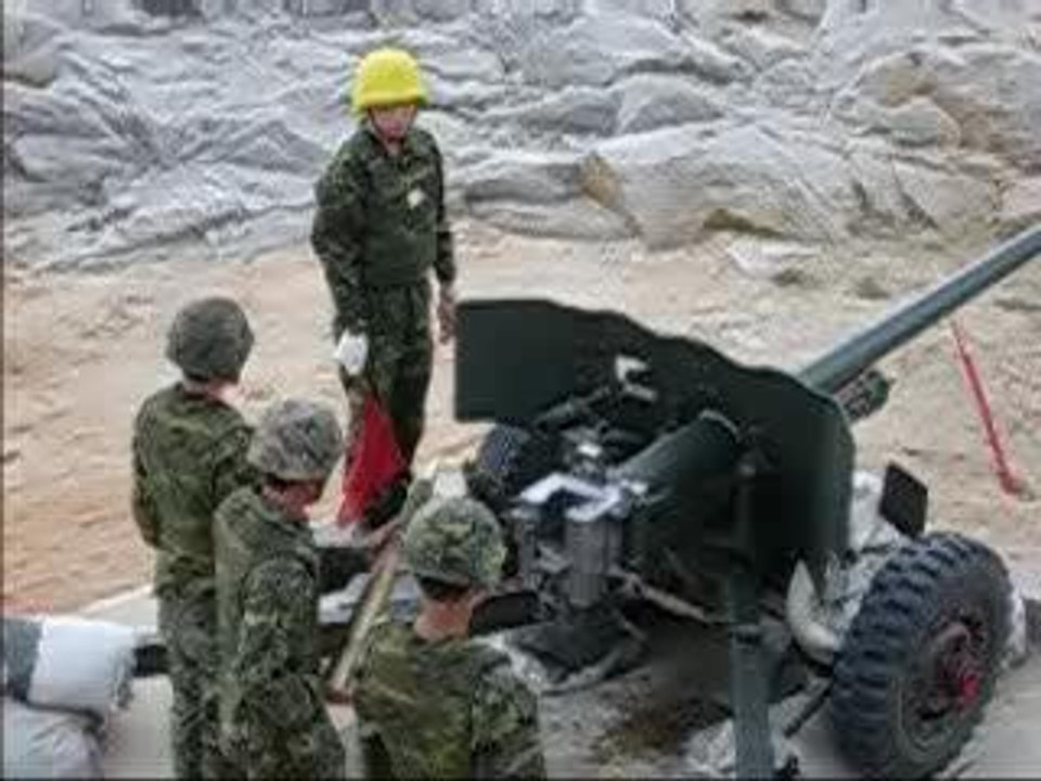a soldier stands to close to artillery