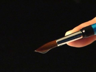 Spring activated ceramic brush