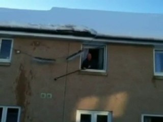 Man clearing roof causes mini avalanche