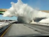 Snow Explodes As Truck Passes Under Bridge