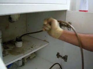 USING A HIGH PRESSURE WATER JET TO CLEAR A BLOCKED SINK.
