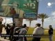 Protesters tearing down Gaddafi's billboard - no comment