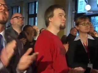 Merkel party retains German state but battle looms