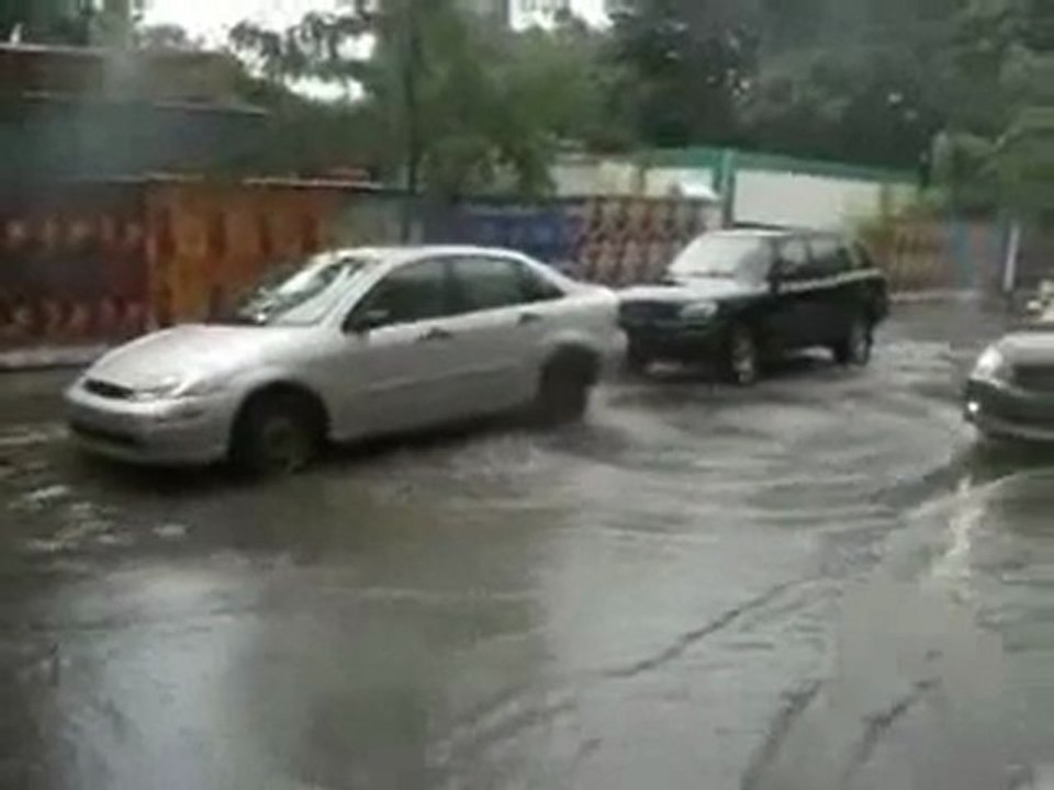 Sewer geyser lifts car