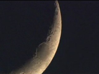 Moon crescent races across the sky