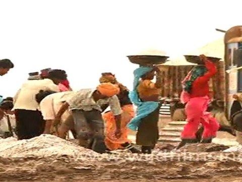 Salt workers loading salt into truck in Rann of Kutch