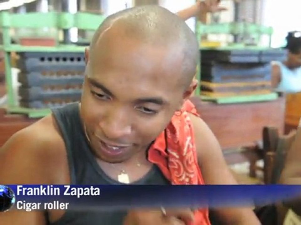 Cigar rollers work their hands, and their minds