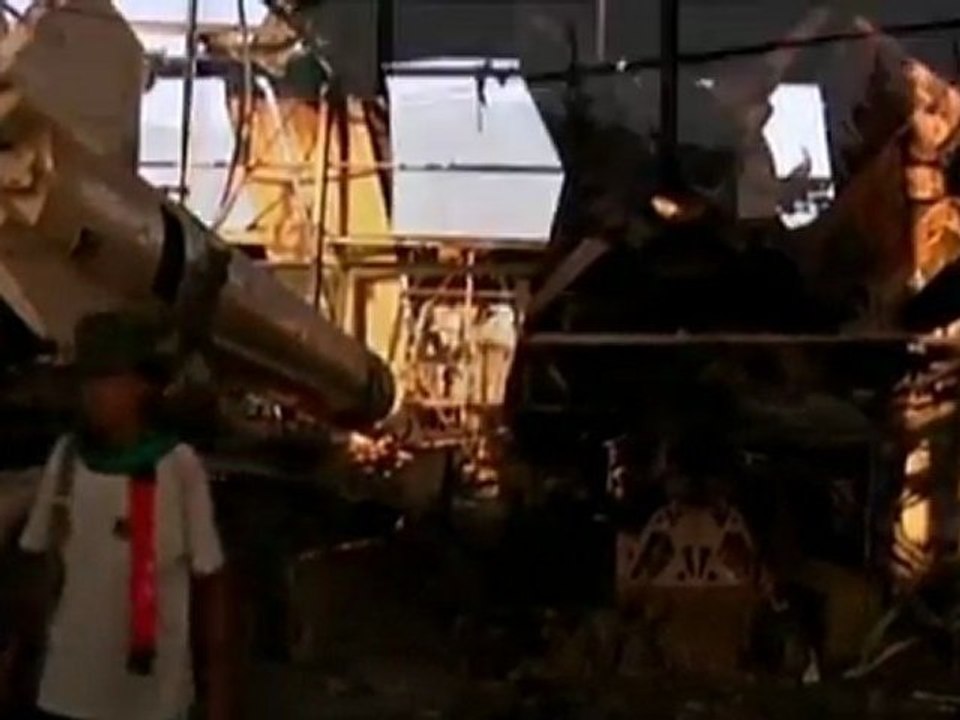 Libyans scour bombed military base for 'spoils of war.'