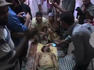Gaddafi's body lies in Misrata market cooler