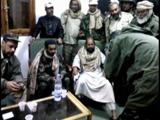 Fighters say Gaddafi son treated well