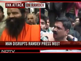 Man throws black ink at Baba Ramdev during a press conference in Delhi