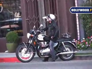 Pink drives her custom Triumph Motorcycle