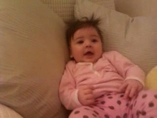 4 old month baby laughing while daddy hitting the balloons round her