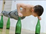 Kid Does Push Ups On Glass Bottles