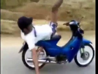Indian man rides scooter backwards