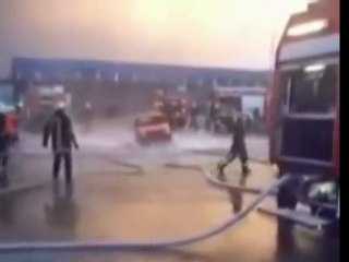 Firemen lift car with water