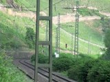 Trains and ships opposite to the town of Filsen beside the river Rhine