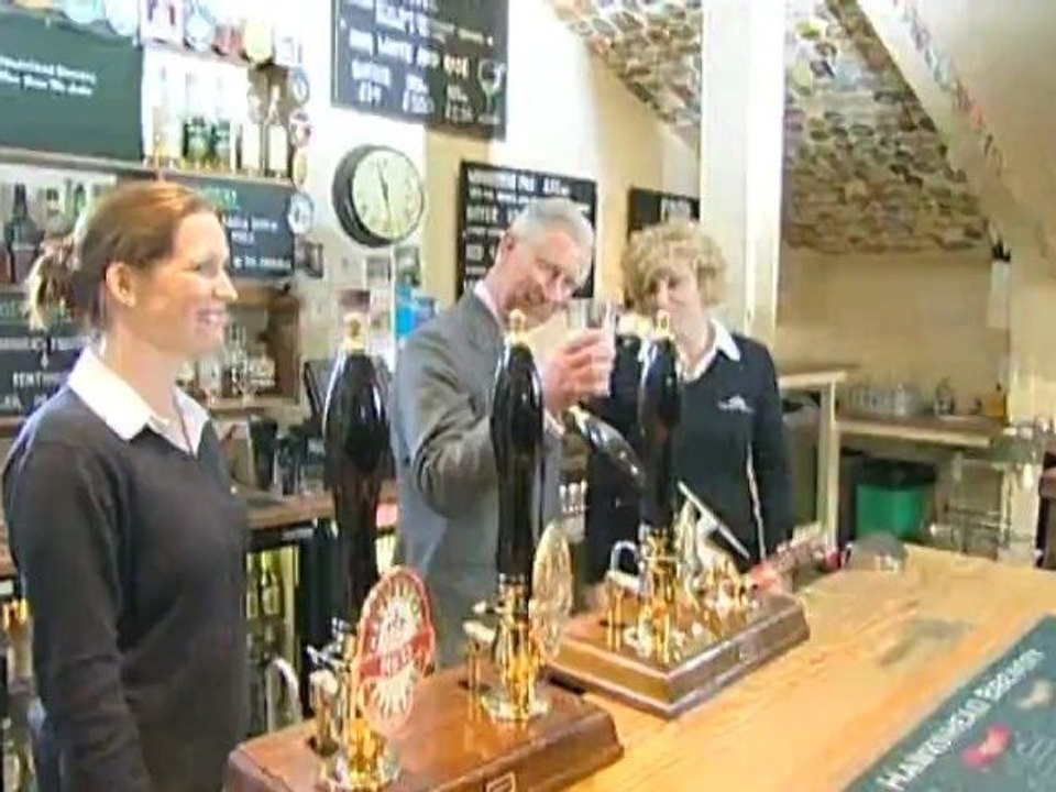 Prince Charles drinks a pint