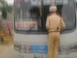 Traffic cop clings to front of moving bus in Vietnam