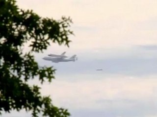 Shuttle zooms past Washington monuments