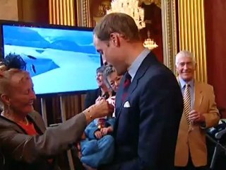 Holding the baby: Kate and Wills get hands on