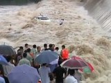 Taxi driver rescued from flooded river in China by crane