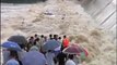Chinese firefighters in dramatic rescue of taxi driver and passenger from flooded dam