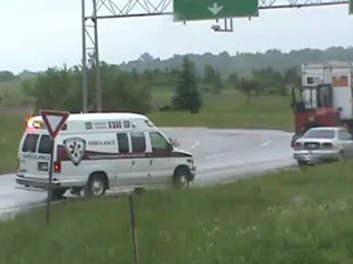 Motorcycle rear ends car, woman injured