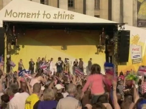 Torvill and Dean skate holding the Olympic torch