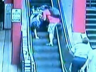 Woman rolls down escalator in wheelchair