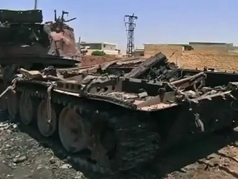 Scorched tanks litter Syrian town